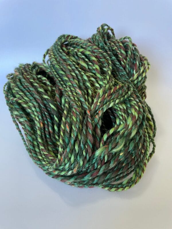 il_fullxfull.4642381158_nk81.jpg Hand spun Shetland yarn combined with merino and sari silk in forest greens.