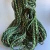 il_fullxfull.4690623057_g2ms.jpg Hand spun Shetland yarn combined with merino and sari silk in forest greens.