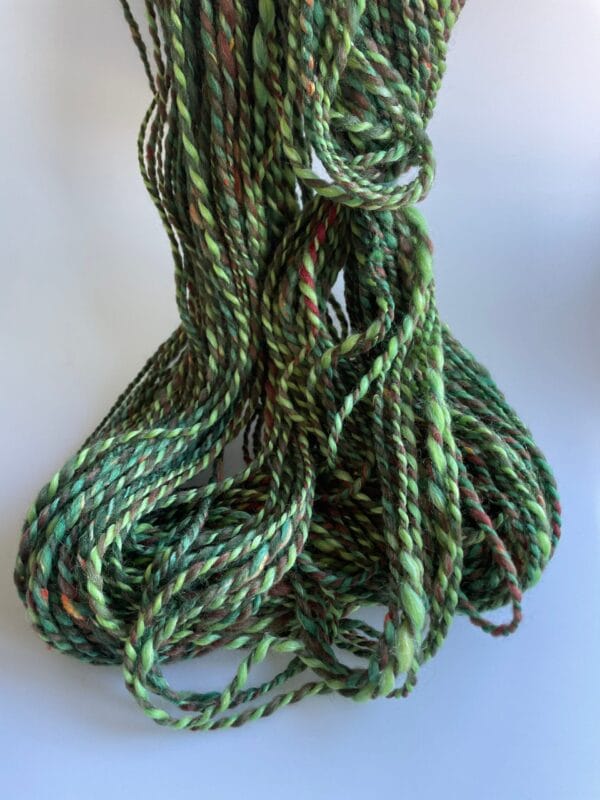 il_fullxfull.4690623057_g2ms.jpg Hand spun Shetland yarn combined with merino and sari silk in forest greens.