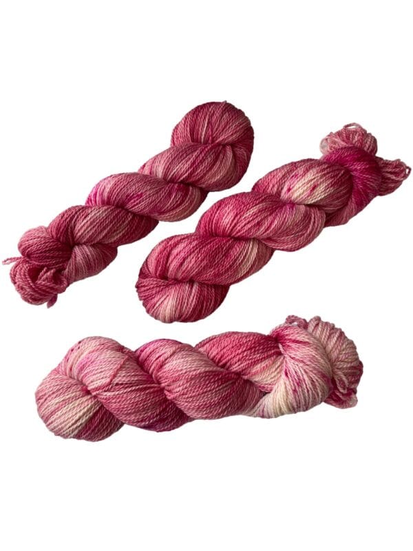 il_fullxfull.5675216354_cueo.jpg Hand dyed superwash Merino and bio nylon sock weight yarn. Warm pink and white with fluorescent speckles.